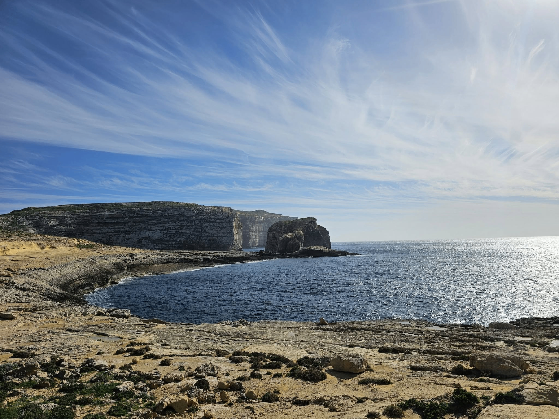 Gozo coastal cliffs and sea under dramatic cloud patterns